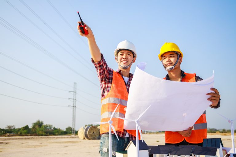Two Electricity engineers working on the power plant. Teamwork industry a concept